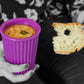 Woman holding Onya reusable purple coffee cup filled with soup. She also holds a slice of artisan bread for dipping. Available at Green Distributors.