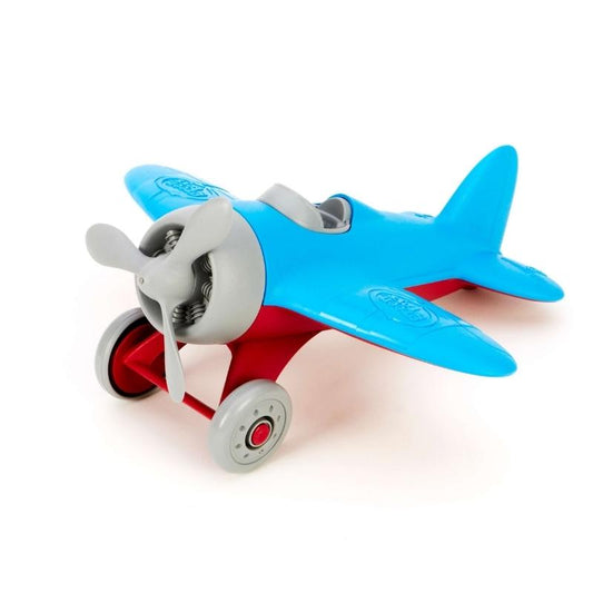 Green Toys Airplane with blue wings, red landing gear, gray propeller, cockpit, and wheels. The airplane is facing to the left. Available at Green Distributors.