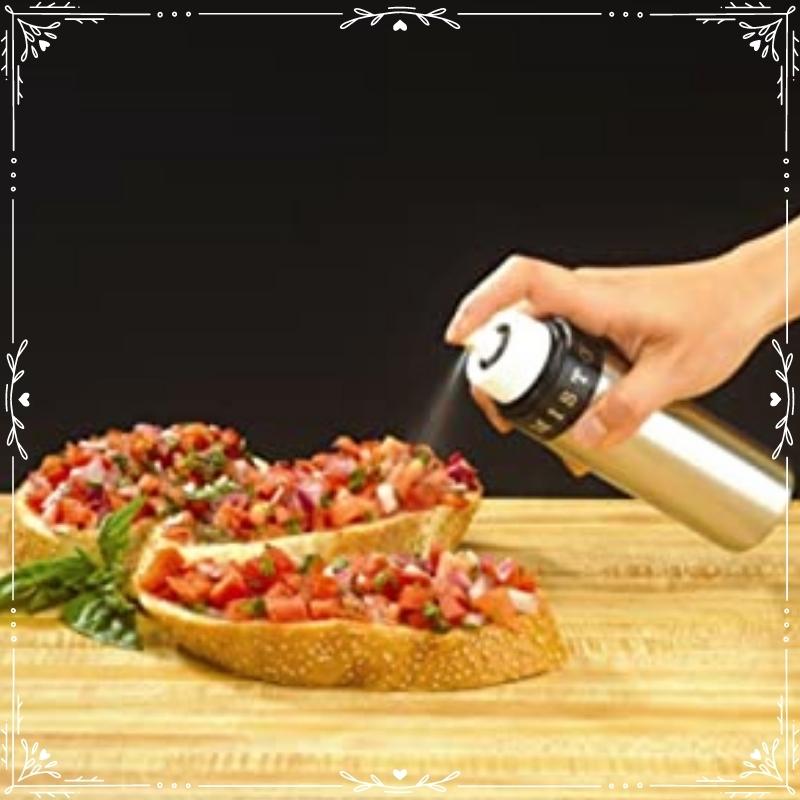 Silver Misto reusable gourmet oil misting bottle being used to add oil to an open face chopped caprese sandwich on artisan bread. Available at Green Distributors.