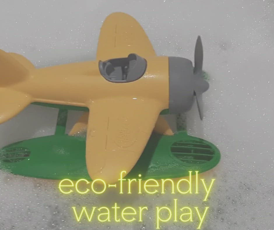 Video of the Green Toys yellow and green seaplane and the blue and yellow submarine floating in a bubble bath. Text says "eco-friendly water play" and "bath toys from milk jugs". Available at Green Distributors.